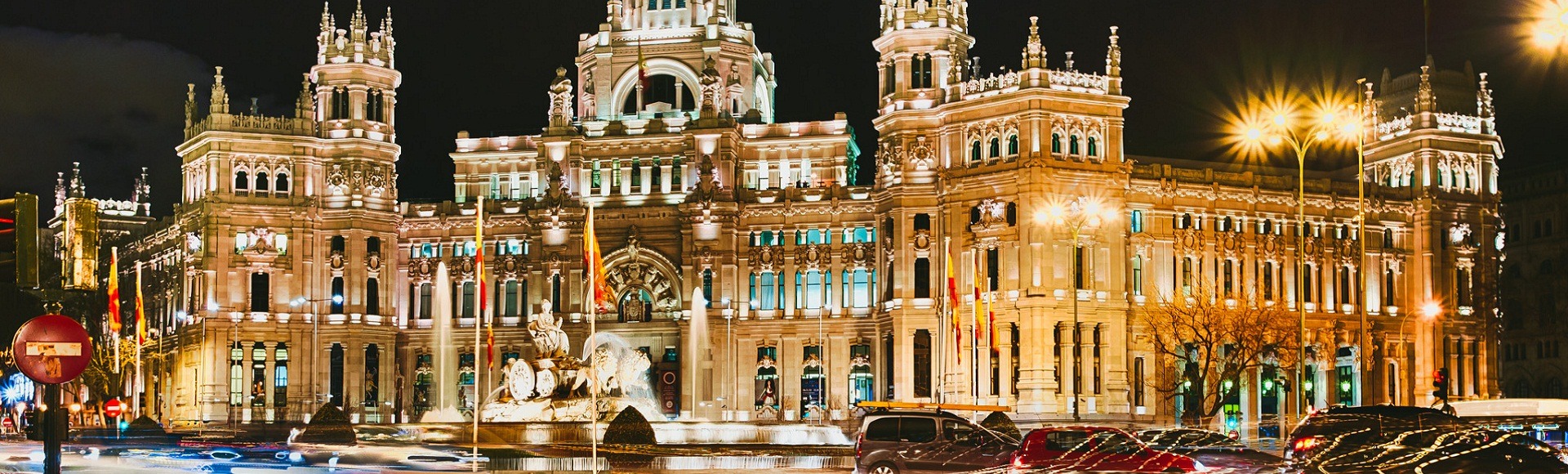 Madrid  Spain

The Plaza de Cibeles is a square with a neo-classical complex of marble sculptures with fountains that has become an iconic symbol for the city of Madrid. It sits at the intersection of Calle de Alcalá (running from east to west), Paseo de Recoletos (to the North) and Paseo del Prado (to the south). Plaza de Cibeles was originally named Plaza de Madrid, but in 1900, the City Council named it Plaza de Castelar, which was eventually replaced by its current name.

It is currently delimited by four prominent buildings: The Bank of Spain, the Palacio de Buenavista, the Palacio de Linares and the Palacio de Cibeles. These constructions are located in four different neighbourhoods from three different adjacent districts: Centro, Retiro and Salamanca.

The building is the the Palace (formerly named Palace of Communication). The cathedral-like landmark was built in 1909 by Antonio Palacios as the headquarters of the postal service. This impressive building was home to the Postal and Telegraphic Museum until 2007 when the landmark building became the Madrid City Hall (Ayuntamiento de Madrid). In the years Cibeles Palace and her fountain have become symbolic monuments of the city (Wikipedia).

Photo details: Exposure 1/6 sec at f/11 (ISO 800), Camera Canon EOS 5D Mark III with a EF17-40mm f/4L USM lens at 33mm. 

Photo by: Iwillbehomesoon. Image license Creative Commons Attribution-NonCommercial-ShareAlike 3.0 Unported (CC BY-NC-SA 3.0).